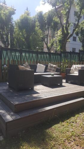 a seating area with couches and tables in a park at Pensione Bianca in Bardonecchia