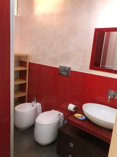 a bathroom with a white toilet and a sink at Sole e Luna in Marina di Modica