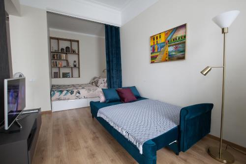 a small bedroom with a bed and a bed and a mirror at Cozy Home Valdemara, free parking, self check-in in Rīga