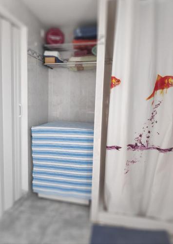 a kitchen with a door open with a shelf with plates at Can Blau in Roses