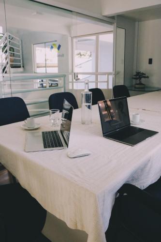 two laptops sitting on top of a table at Hotel Solaris in São Miguel dʼOeste