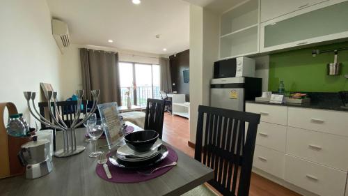 a kitchen and dining room with a table and chairs at Teddy@Thammasart in Pathum Thani