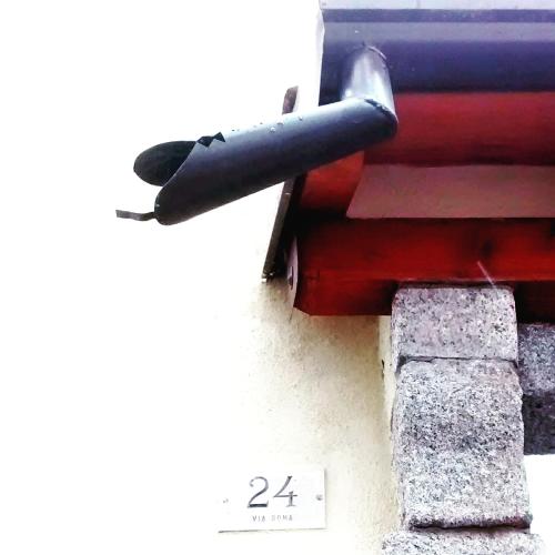 a black pipe sticking out of the side of a building at Ostello Sociale Borgo Venno in Lavenone