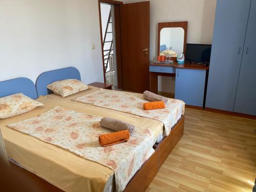 two twin beds in a room with a mirror at Hotel Atanasov 1 in Primorsko