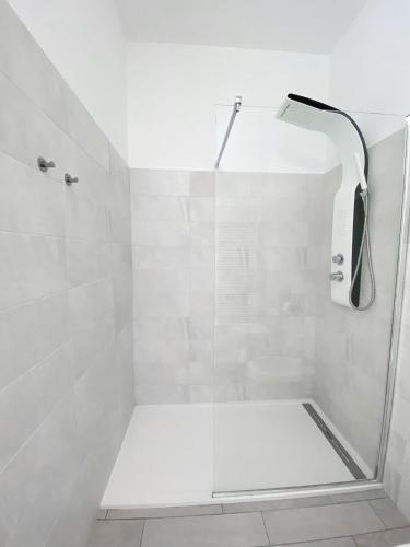 a bathroom with a shower with a white shower at Vista sul Forte in Gavi