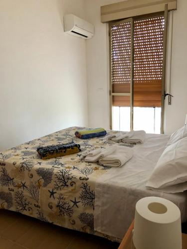 a bedroom with a bed with a comforter on it at Relax Near The Sea in Noto Marina