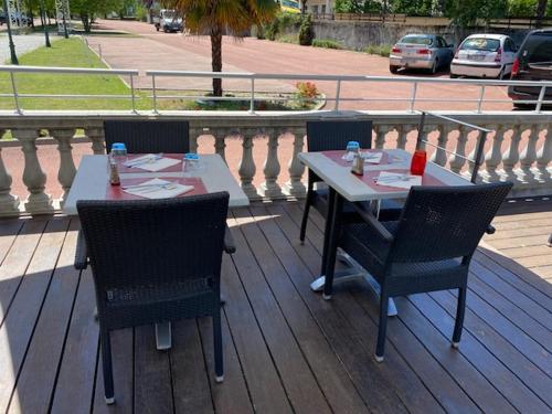 a table and chairs sitting on a wooden deck at Casino Circus d'Allevard in Allevard