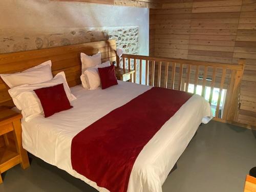 a bedroom with a large bed with red and white pillows at Casino Circus d'Allevard in Allevard