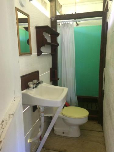 a bathroom with a sink and a toilet at Cabaña Rio Lagarto in Lívingston