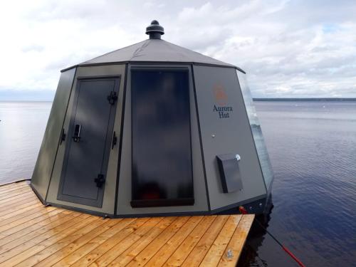 a cabin on a boat on the water at Arctic Lake Experience Oulujärvi Igloos in Kajaani