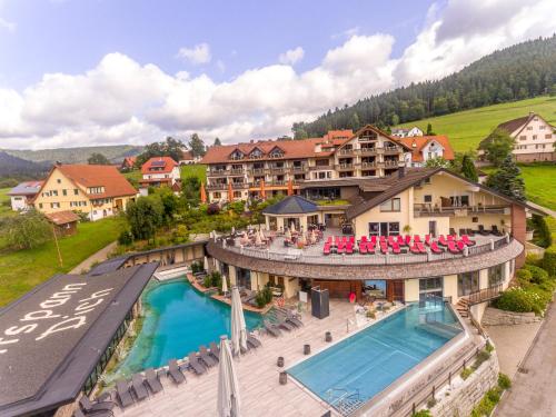 an aerial view of a resort with a swimming pool at Hotel Heselbacher Hof in Baiersbronn