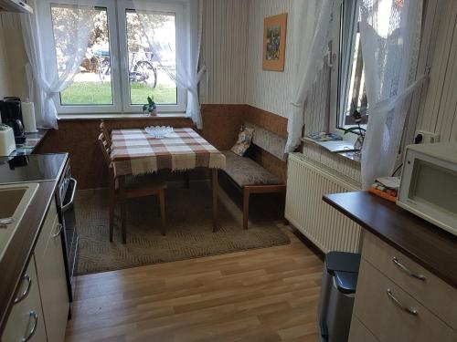 a small kitchen with a table and a window at Fewo Kaiser in Wolmirstedt