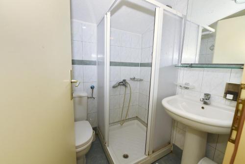 a bathroom with a shower and a toilet and a sink at Villa Lucija in Ohrid