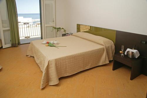 a bedroom with a bed with flowers on it at Castellammare Smart Rooms in Castellammare del Golfo