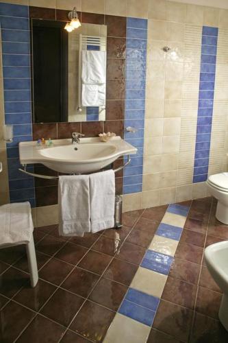 a bathroom with a sink and a toilet at Castellammare Smart Rooms in Castellammare del Golfo