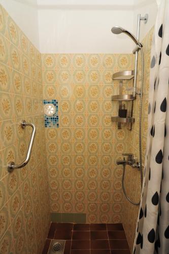 a bathroom with a shower and a tiled floor at Puntin Rooms apartman in Korčula