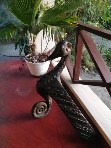 a statue of a seahorse sitting on a bench at Sunset villas Tropical Garden House in Kilifi
