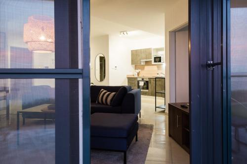 a living room with a couch and a kitchen at Apartman Balaton in Keszthely