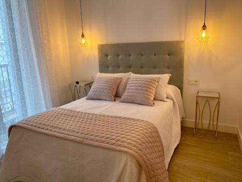 a bedroom with a large white bed with two pillows at EL HOSPEDAJE DEL REY in Trujillo