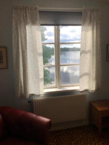 a window with a view of a body of water at Älvtomt in Krylbo