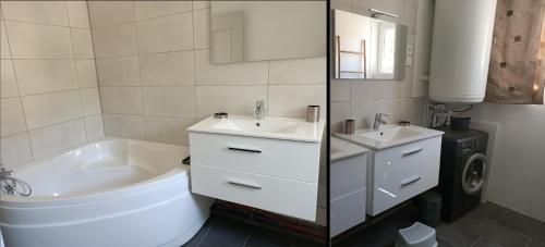 een witte badkamer met een bad, een wastafel en een bad bij Location Bord de mer, villa de vacances 9 personnes - jardin in Valras-Plage