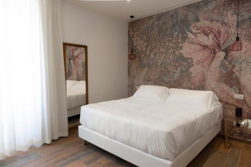 A bed or beds in a room at Il Caruggio Rooms&Breakfast