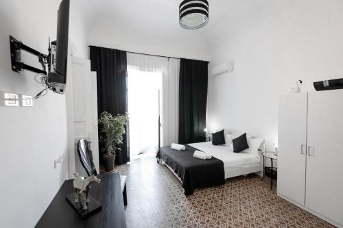 a hotel room with a bed and a window at Pegaso in Catania