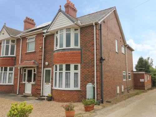 a red brick house with white windows at The Gables in York