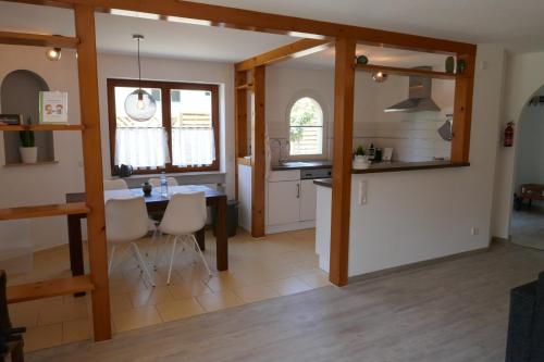 a kitchen and dining room with a table and chairs at Ferienwohnung Schwarzwaldliebe nahe Freiburg, Terrasse in Bollschweil