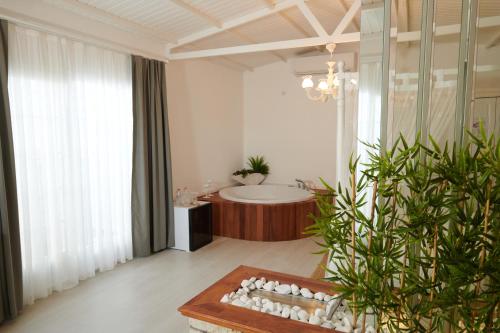a bathroom with a bath tub and a large window at Gobene Alacati in Alacati