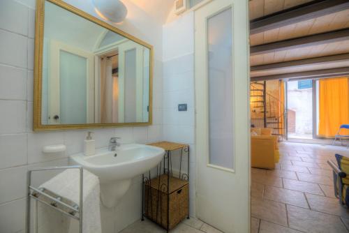 a bathroom with a sink and a mirror at Scuderie Maresca in Ostuni