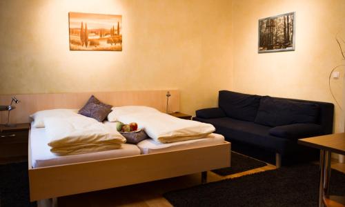 a living room with a bed and a couch at Gasthof Familie Hutter in Rattersdorf