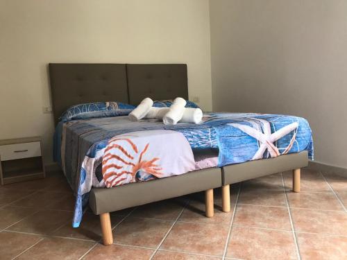 Una cama con dos almohadas encima. en Bella Posada B&B, en Buggerru