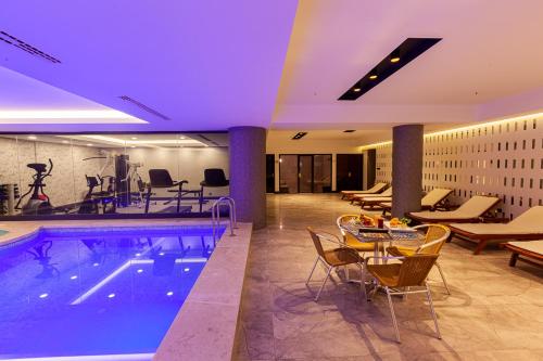 a hotel room with a pool and a table and chairs at Ilci Residence Hotel in Ankara