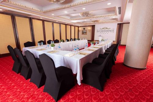 a conference room with a long table and black chairs at Ilci Residence Hotel in Ankara