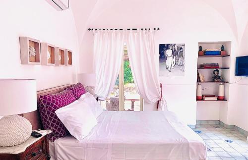 מיטה או מיטות בחדר ב-Marunnella Suites