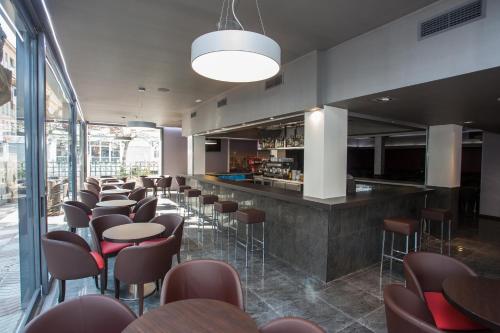 a bar with chairs and tables in a restaurant at Hotel Maria del Mar in Lloret de Mar
