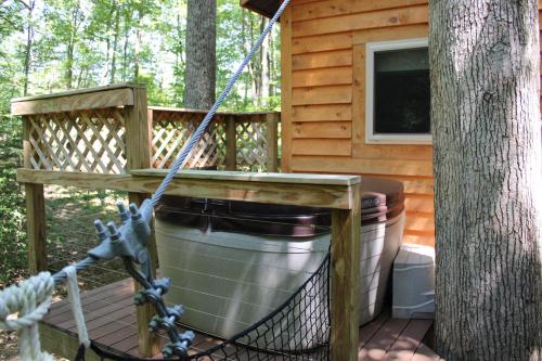 a porch of a cabin with a tree at Country Road Cabins in Hico