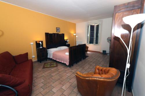 a living room with a bed and a couch at casadiviaappia in Imola