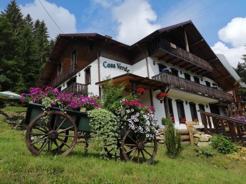 a cottage with a flower cart in front of it at Casa Verde in Voronet