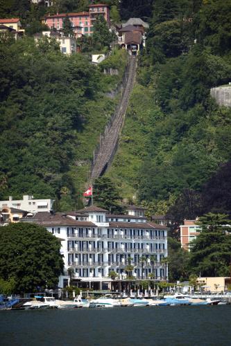 a large building on the side of a mountain at Hotel Lido Seegarten in Lugano