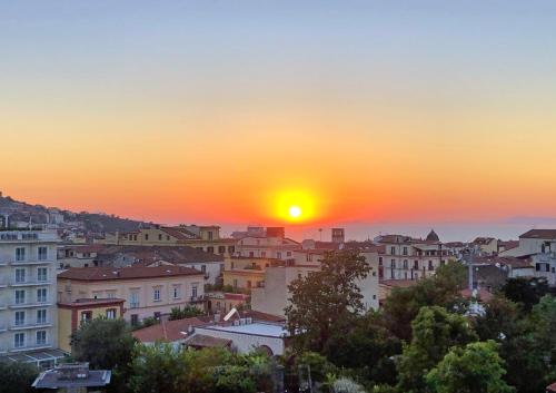 a view of a city at sunset at Sunset Home Sorrento in Sorrento