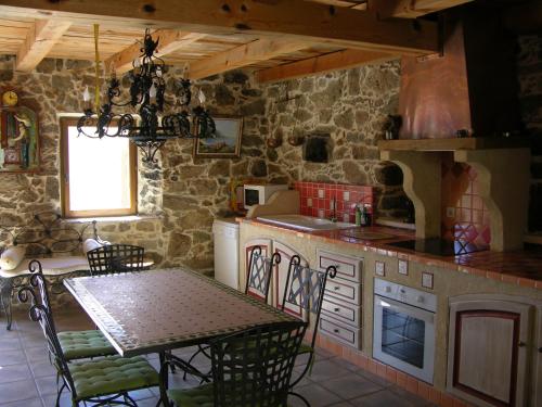 a kitchen with a table and a dining room at Maison Le Rêve in Evisa