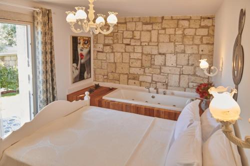 a dining room with a bath tub and a table at Gobene Alacati in Alacati