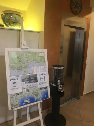 a parking meter next to a map and a sign at Kalaskiso' in Giardini Naxos
