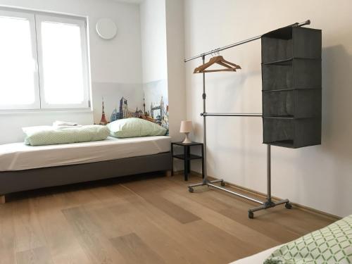 1 dormitorio con 1 cama, vestidor y ventana en Townus Apartments Wiesbaden, en Wiesbaden