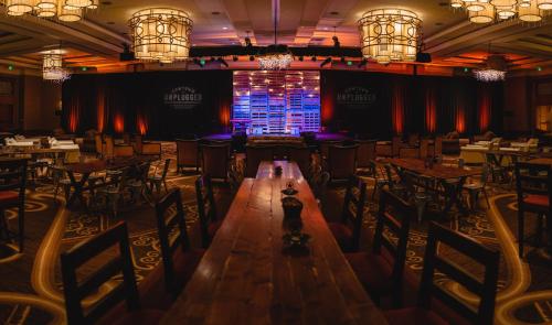 a person standing in the middle of a room with tables and chairs at Omni Fort Worth Hotel in Fort Worth