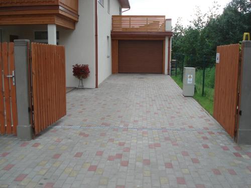 a building with a garage door and a driveway at Exclusive Mansion Jurmala in Jūrmala