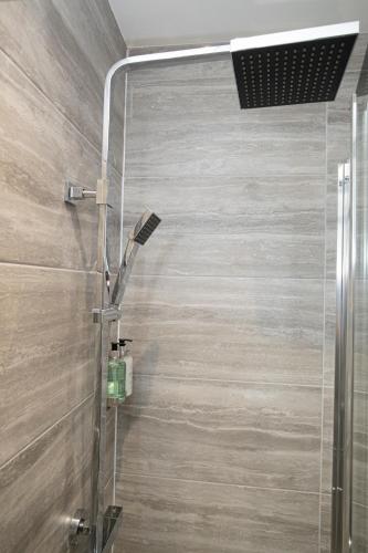 a shower with a glass door in a bathroom at Lynwood House in Southport