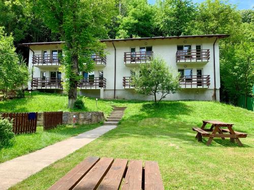 a picnic bench in front of a building at Casa Flori de Sare in Slănic